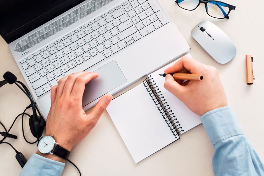 top-view-of-a-freelancer-making-notes-while-workin-2023-03-07-04-37-15-utc.jpg